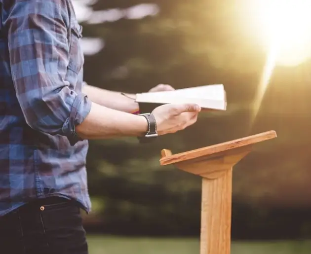 shallow-focus-shot-male-reading-bible-while-standing-near-podium1 shallow-focus-shot-male-reading-bible-while-standing-near-podium1